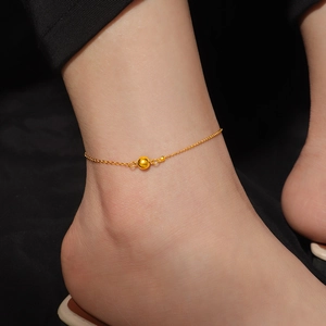 Minimalist 18K gold plated titanium steel anklet with a small polished bead on model ankle