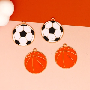 Detail view of colorful enamel soccer and basketball alloy charms for DIY jewelry.
