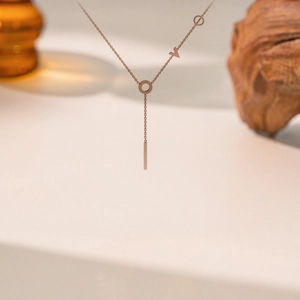 Rose gold Y-lariat necklace featuring LOVE letter design and a sleek bar pendant