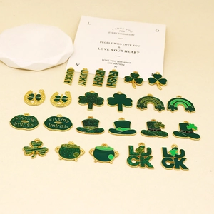 Detailed view of St. Patrick's Day themed green enamel shamrock and lucky letter charms
