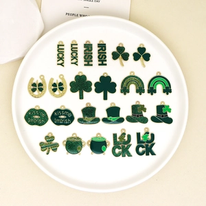 Detail view of green St. Patrick's Day enamel charms featuring shamrocks and lucky symbols.