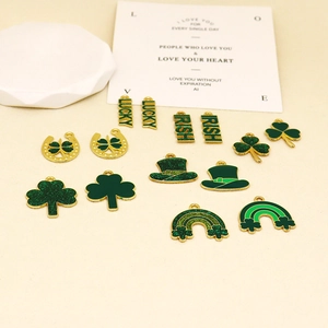 Macro view of green Irish festival clover charms and lucky enamel pendants for DIY jewelry