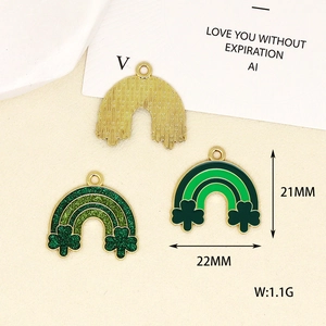 Detailed view of green shamrock and rainbow enamel charms for St. Patrick's Day DIY jewelry