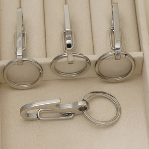 Multi-functional stainless steel keychain with bottle opener tool on beige velvet display
