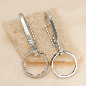 Polished 304 stainless steel multi-functional car keychain on a textured stone surface