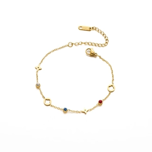 Detailed macro view of gold stainless steel bracelet with colorful stones and clover motifs.