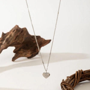 Elegant silver heart necklace with Love engraving on a minimalist stainless steel chain