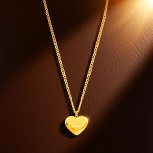 Macro view of golden heart pendant with Love engraving on a premium leather surface