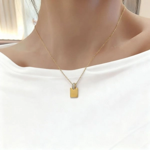 Minimalist 18K gold plated rectangular pendant necklace with zircon detail on model