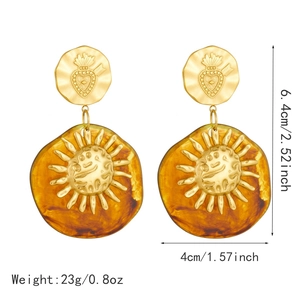 Vintage gold and amber resin earrings with engraved sun emblem, 6.4cm height