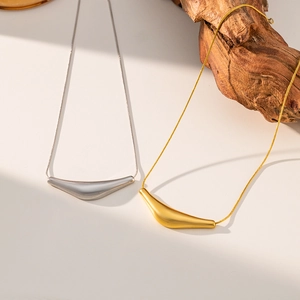 Detail of minimalist gold and silver V-shaped curved bar pendant necklaces with snake chains