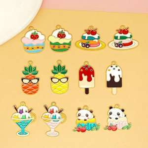 Close-up of colorful summer dessert enamel charms with ice cream, cakes and pineapple designs