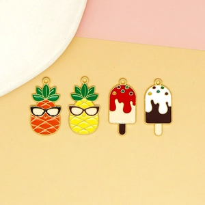 Close-up of colorful enamel alloy charms featuring cute pineapple and popsicle designs