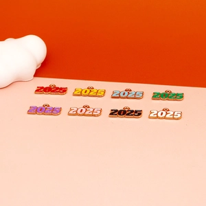 Detail view of various colorful 2025 alloy enamel year charms for DIY jewelry making projects
