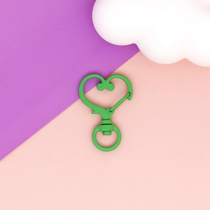 Detail of vibrant green heart-shaped lobster clasp for DIY jewelry and keychain accessories