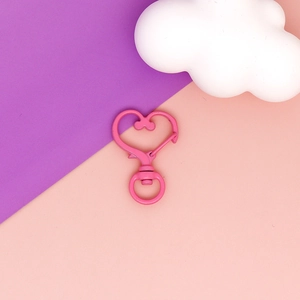 Close-up of pink heart-shaped swivel lobster clasp for DIY keychain crafts