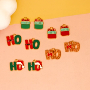 Close-up of festive HO letters and gift charms for Christmas DIY jewelry crafts