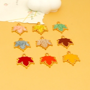 Detail view of colorful alloy enamel maple leaf charms for DIY jewelry making pendants