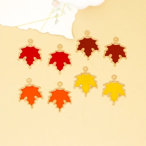 Detailed view of colorful enamel maple leaf alloy pendants for DIY jewelry making.