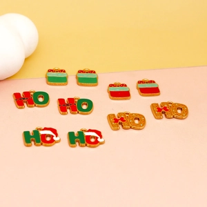 Detail showing festive HO HO and gift box enamel charms for Christmas DIY jewelry