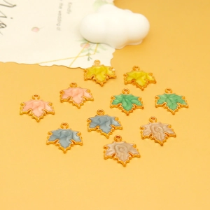 Macro view of colorful maple leaf enamel charms for creative DIY jewelry making projects