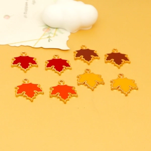 Detailed macro view of colorful maple leaf enamel alloy charms in vibrant autumn shades