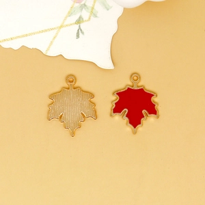 Detailed view of red maple leaf alloy charms showing both front and back textured finish.