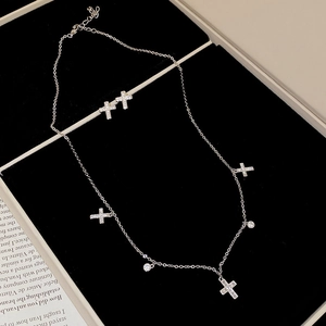 Silver-toned cross necklace and earring set with sparkling rhinestones and elegant stones