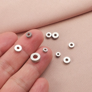 Macro detail of stainless steel knurled gear spacer beads for DIY jewelry making