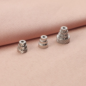 Detailed macro view of textured stainless steel spacer beads for DIY jewelry accessories