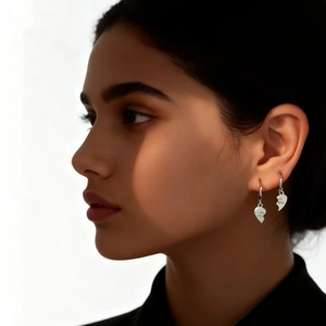 Detail shot of S925 silver heart earrings with Best Friends engraved on the polished hoops