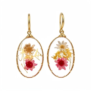 Pastoral style oval resin earrings with real dried flowers and elegant gold hooks.