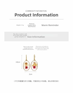 Detailed macro view of oval resin drop earrings with colorful dried flowers and gold hooks