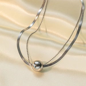 Double-layered stainless steel necklace featuring a polished silver ball pendant on silk