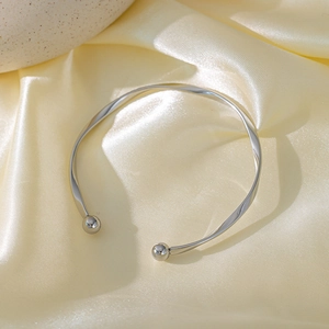 Minimalist silver Mobius wave choker with polished sphere ends on yellow silk