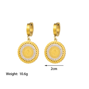 Close-up of gold coin earrings with portrait carving and white stone accents