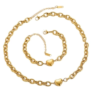 Close-up of golden chunky chain jewelry set with polished heart pendants on white background