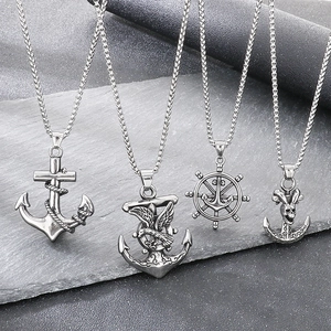 Set of four vintage nautical pendants including anchor, ship wheel, and skull designs.