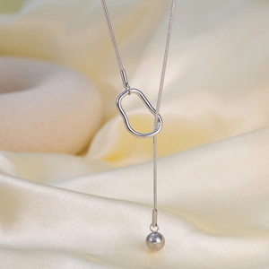 Silver snake chain necklace with irregular geometric ring and round bead pendant