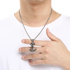 Detailed view of a retro punk style stainless steel skull anchor pendant necklace for men