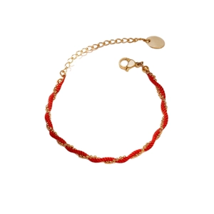 Elegant red braided bracelet with spiral gold beads and adjustable lobster clasp