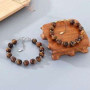 Detailed view of Tiger's Eye beaded bracelets with gold and silver steel accents