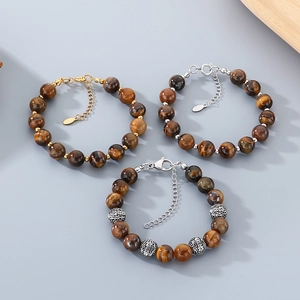 Detail view of three retro tiger eye stone beaded bracelets with stainless steel chains.