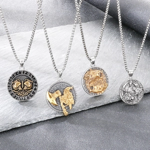 Detailed macro view of four Viking Norse mythology pendants with runes on slate background