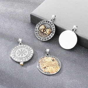 Detailed view of Norse Viking wolf and Vegvisir compass pendants in vintage titanium steel