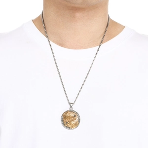 Detailed view of Viking wolf and raven titanium steel pendant worn by male model