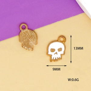 Macro view of white enamel skull charms showing 13mm height and 9mm width detail