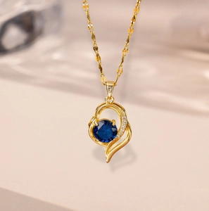 Elegant 18k gold heart pendant necklace with faceted blue sapphire and white diamonds