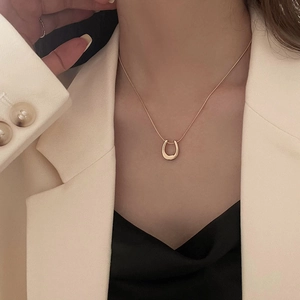 Minimalist gold U-shaped pendant necklace for women with a polished titanium steel finish