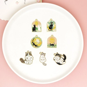 Detailed view of various colorful cat enamel charms arranged in a white ceramic dish